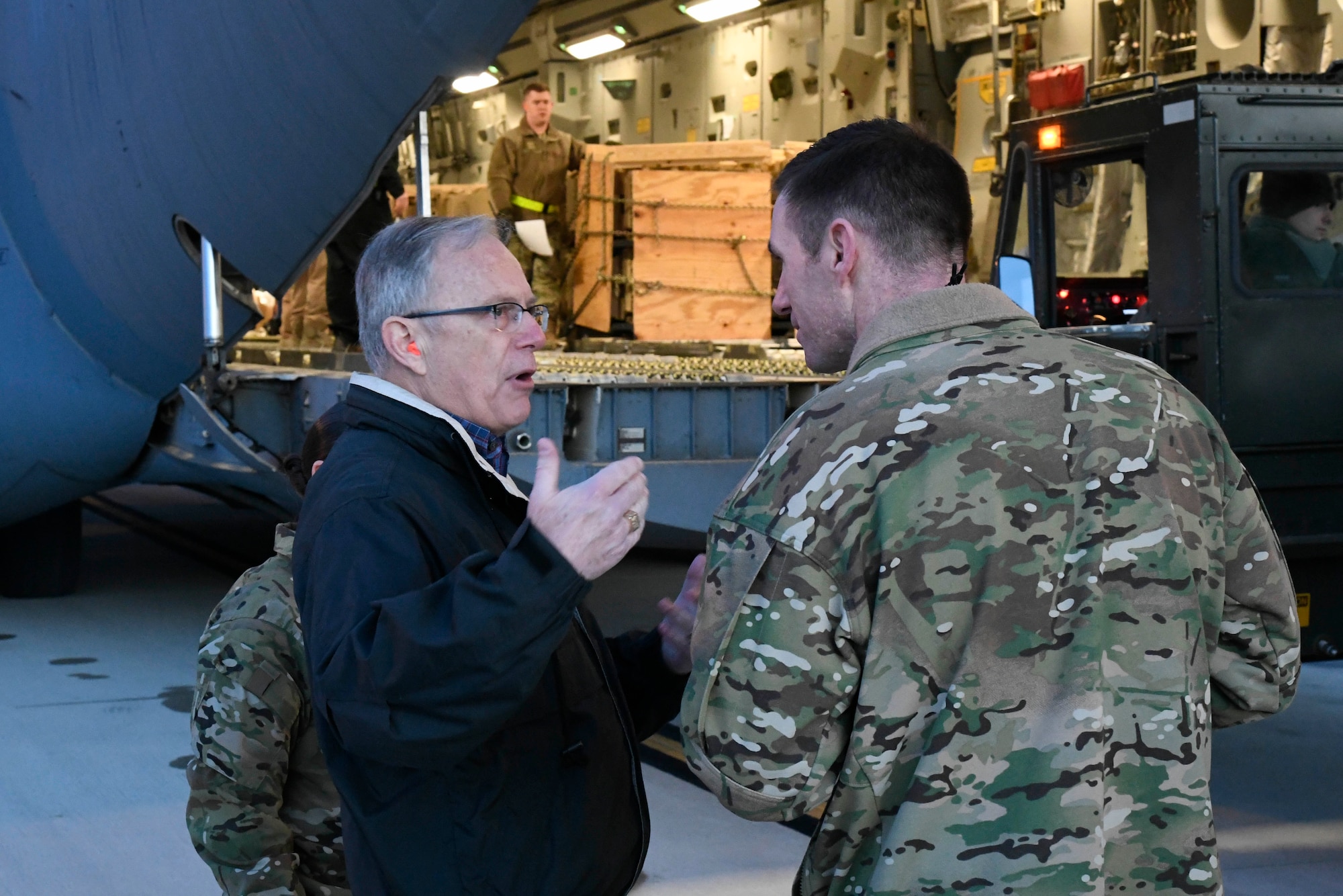 The Honorable Dr. Bruce D. Jette, assistant secretary of the Army (acquisition, logistics and technology), speaks with 1st Lt. Chris Ford, 436th Aerial Port Squadron, in front of a United Arab Emirates air force C-17 Globemaster III Jan. 26, 2020, at Dover Air Force Base, Del. Jette visited Dover AFB to oversee a shipment of Patriot Advanced Capability 3 Missile Segment Enhanced missiles to the UAE. (U.S. Air Force photo by Senior Airman Eric M. Fisher)