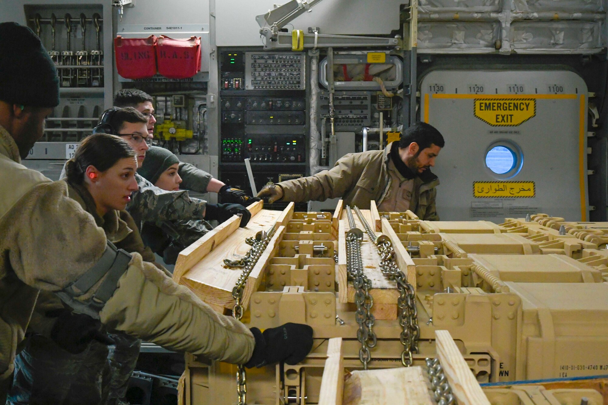 Airmen assigned to the 436th Aerial Port Squadron and a member of the United Arab Emirates air force (UAEAF) 15th Strategic Airlift Squadron move cargo into position in a UAEAF C-17 Globemaster III Jan. 26, 2020, at Dover Air Force Base, Del. Members of the U.S. and UAE air forces worked together to load a shipment of Patriot Advanced Capability 3 Missile Segment Enhanced missiles destined for the UAE. (U.S. Air Force photo by Senior Airman Eric M. Fisher)