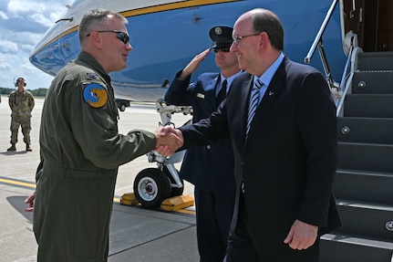 Col. John Pogorek, 157th Air Refueling Wing commander, greets Matthew Donovan, the acting secretary of the Air Force, on the flight line at Pease Air National Guard Base, Aug. 8, 2019.