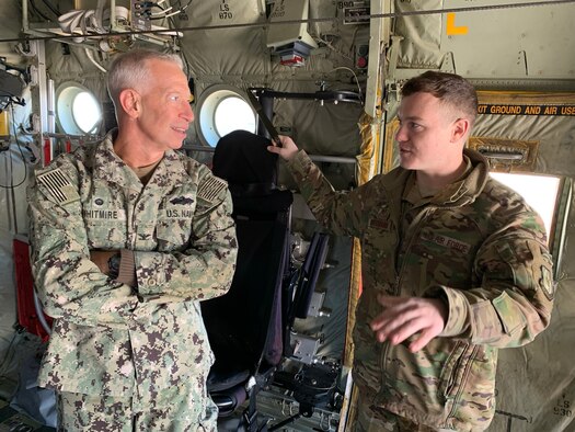 Navy Capt. Bill Whitmire, Naval Construction Battalion Center Gulfport commander, listens to Tech. Sgt. Anthony DiStefano, 815th Airlift Squadron loadmaster, talk about the C-130J Super Hercules aircraft and details about his career field Feb. 21 at Keesler Air Force Base, Miss. Navy Seabees had the opportunity to meet with the Reserve Citizen Airmen of the 403rd Wing and learn about the different missions across the wing. (U.S. Air Force photo by Christopher Carranza)