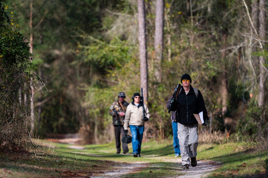 A photo of Airmen walking through a sporting clay course