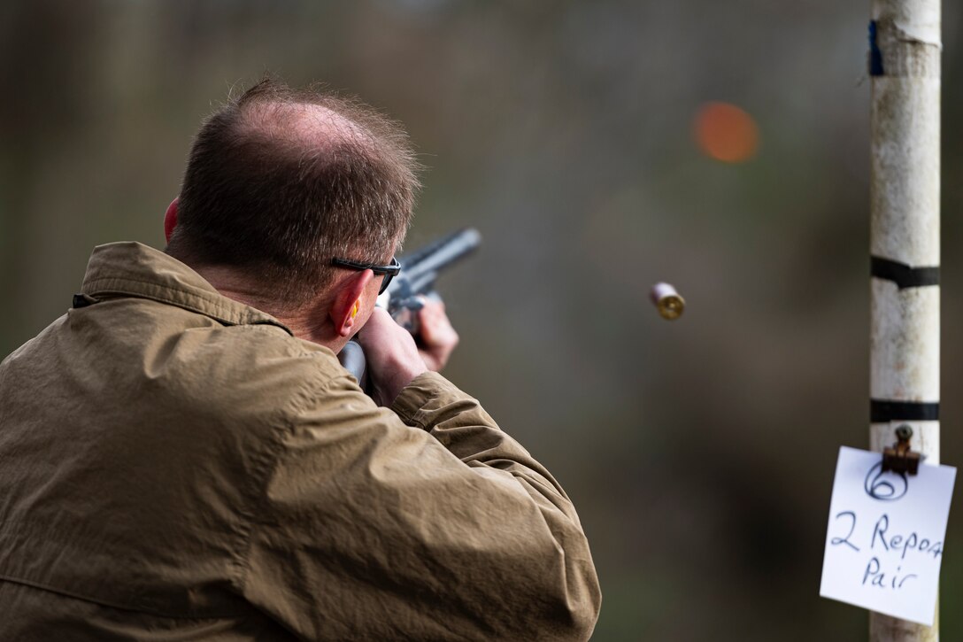 A photo of an Airman shooting a clay pigeon