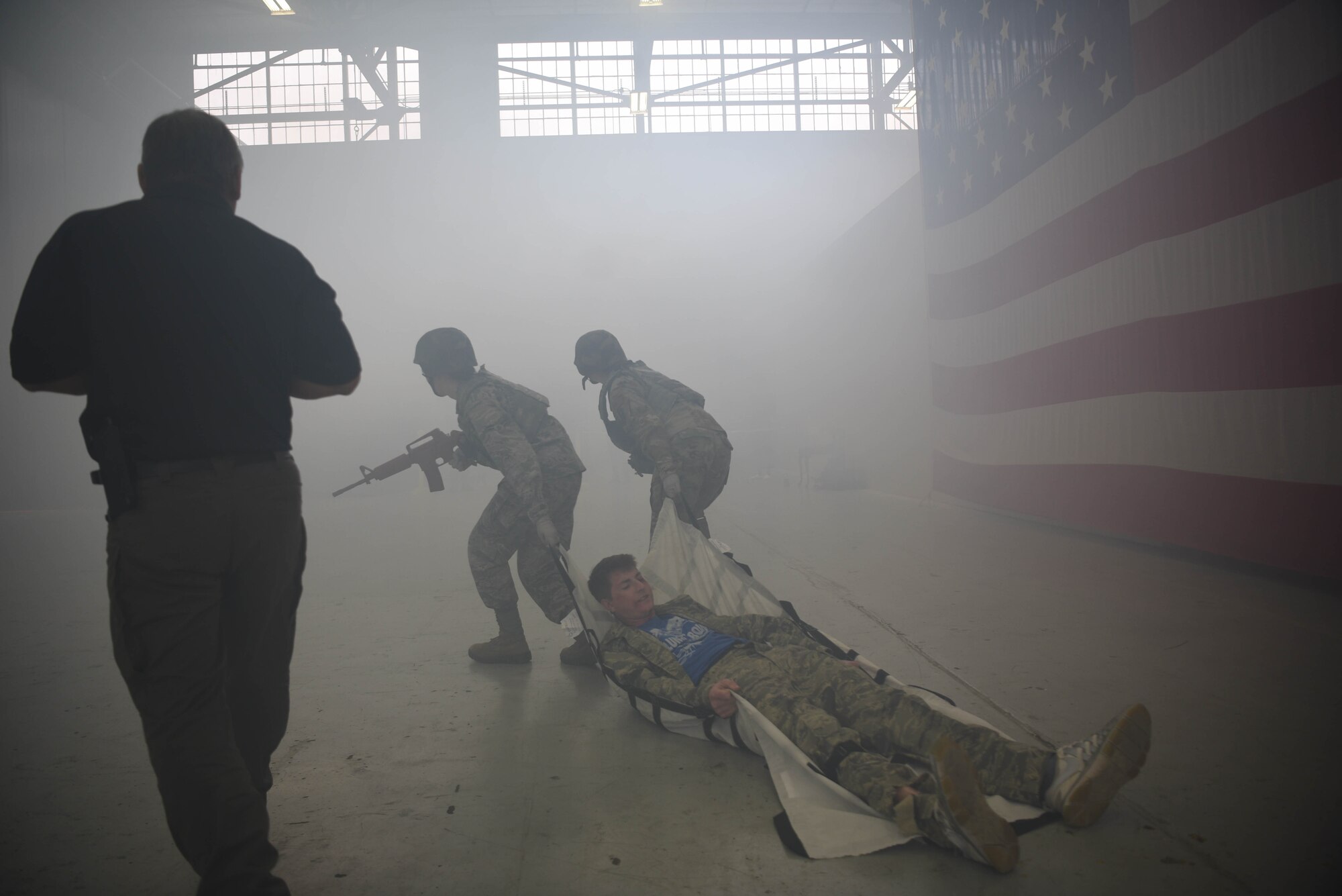 Airmen from the 14th Medical Group carry off a ‘wounded’ actor during the Tactical Combat Casualty Care Course in the Walker Center Feb. 23, 2020, on Columbus Air Force Base Miss. The TCCC training is a simulated immersion training on stabilizing trauma victims from common battlefield injuries such as hemorrhage, airway obstruction and shock. (U.S. Air Force photo by Airman 1st Class Jake Jacobsen)