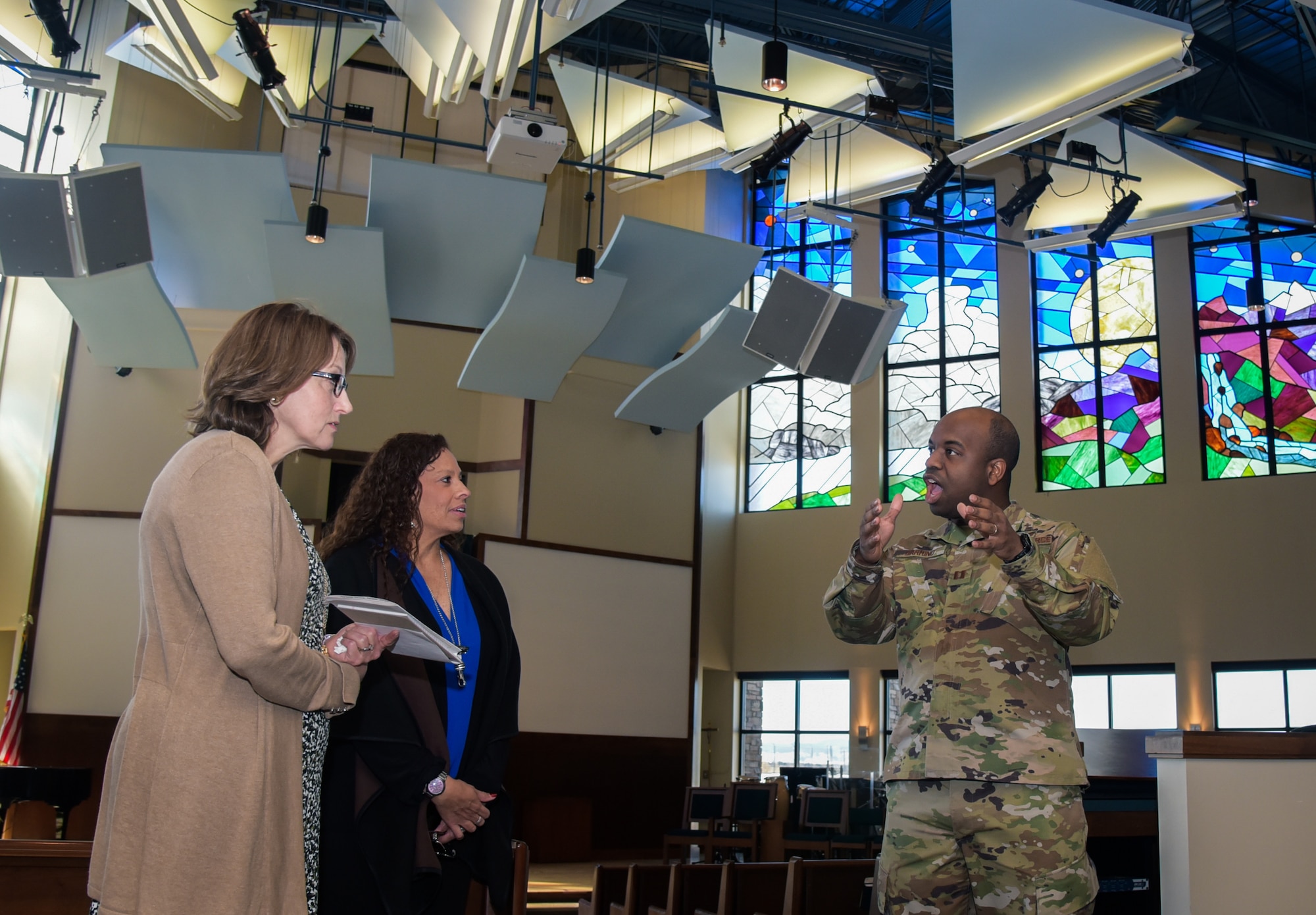 From left to right, Mrs. Tonia Shaw, the Combined Force Space Component commander, U.S. Space Command spouse, Mrs. Alicia Pepper, the 460th Space Wing commander’s spouse and Chaplain (Captain) Travis Barrino, 460th Space Wing chaplain, discuss services provided at the Fellowship Hall, Buckley Air Force Base, Colo., Feb. 21, 2020.