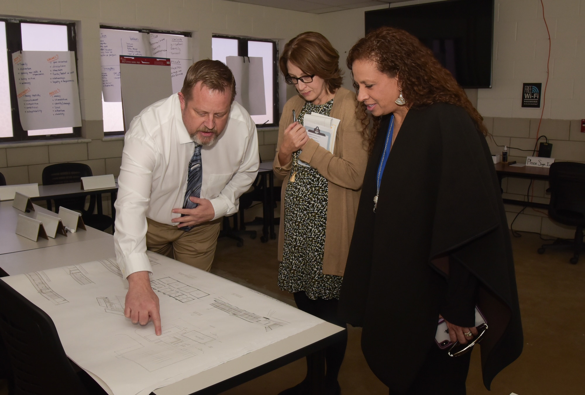 From left to right, Mr. David Conner, 460th Force Support Squadron Force Development Flight chief, Mrs. Tonia Shaw, the Combined Force Space Component commander, U.S. Space Command spouse, and Mrs. Alicia Pepper, the 460th Space Wing commander’s spouse looks at plans for the expansion of the Professional Development Campus on Buckley Air Force Base, Colo. Feb. 21, 2020.