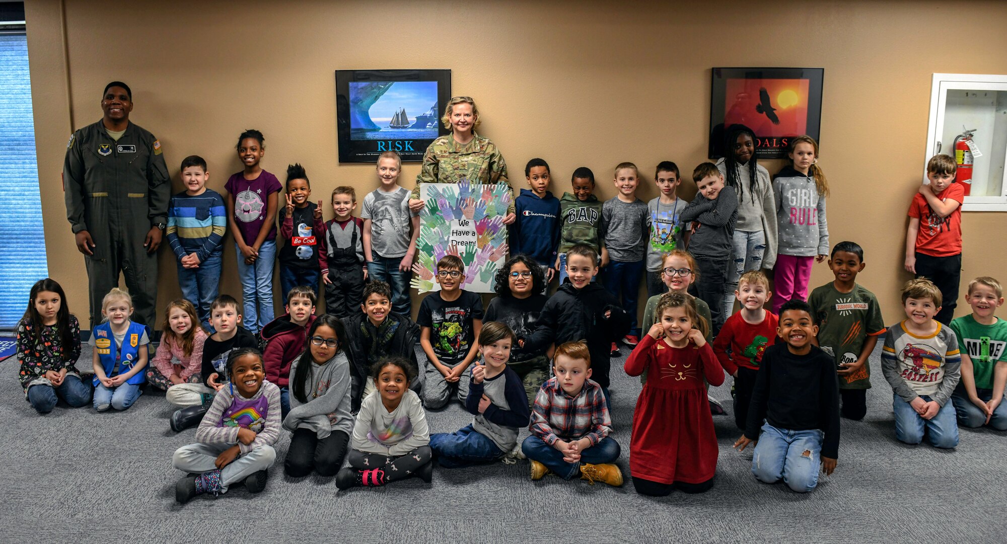 Col. Jennifer Reeves, 341st Missile Wing commander, and Capt. Cornelius Hall, 341st Operations Group standards and evaluations evaluator, pose for a group photo with children during a Black History Month event at the Youth Center Feb. 12, 2020, at Malmstrom Air Force Base, Mont.