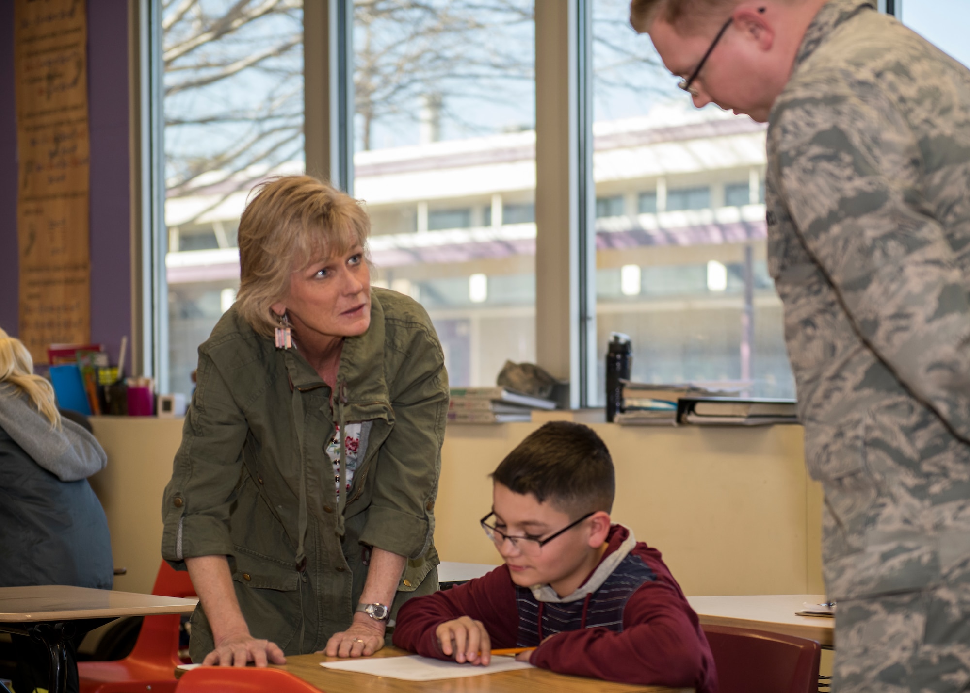 Wendy Winters, a Desert Junior-Senior High School teacher, and 1st Lt. Joshua Rice, 772nd Test Squadron, tutors a student at Edwards Air Force Base, Feb. 19. (Air Force photo by Giancarlo Casem)
