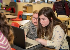 1st Lt. Joshua Rice, 772nd Test Squadron, offers mathematics advice to a Desert Junior-Senior High School student at Edwards Air Force Base, Feb. 19. (Air Force photo by Giancarlo Casem)