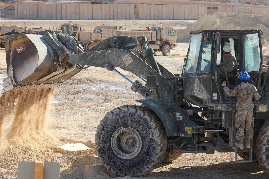 Bulldozer moves dirt.