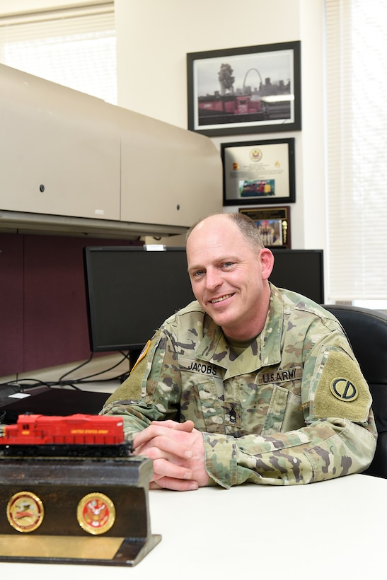 Army Reserve Sgt. 1st Class James Jacobs, Training NCO, Headquarters & Headquarters Company, 85th U.S. Army Reserve Support Command, pauses for a photo at his desk. Jacobs is an 88 Uniform (Railway Specialist) with more than 20 years of experience in Army rail operations.