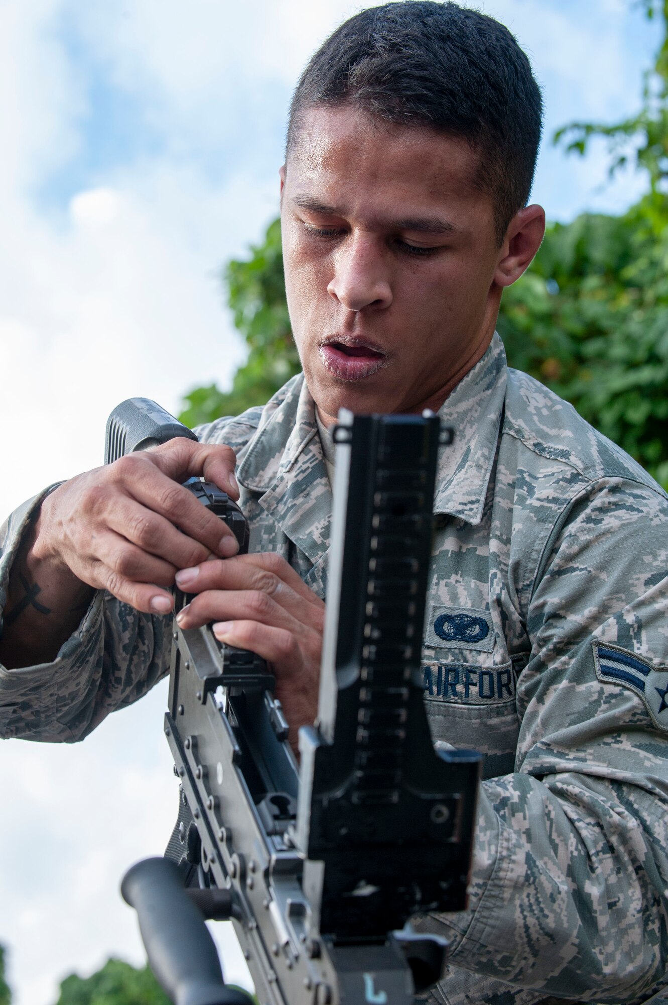 U.S. Air Force Airman 1st Class Samuel Gonzales, 18th Security Forces Squadron armorer, assembles an M240 machine gun during the Defenders Challenge Feb. 13, 2020, at Kadena Air Base, Japan. The members participated in the Defenders Challenge, an event challenging participants to run through an obstacle course designed to test their physical and mental abilities. (U.S. Air Force photo by Naoto Anazawa)