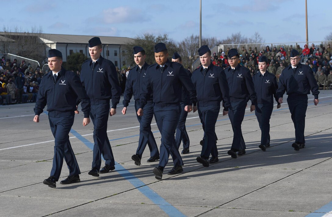 Members of the 334th Training Squadron regulation drill team perform during the 81st Training Group drill down on the Levitow Training Support Facility drill pad at Keesler Air Force Base, Mississippi, Feb. 21, 2020. Airmen from the 81st TRG competed in a quarterly open ranks inspection, regulation drill routine and freestyle drill routine. Keesler trains more than 30,000 students each year. While in training, Airmen are given the opportunity to volunteer to learn and execute drill down routines. (U.S. Air Force photo by Kemberly Groue)