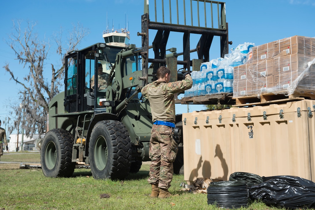 An Airman guides a 10K all-terrain forklift to place supplies for palatalization for camp tear-down during the redeployment process of Exercise Turbo Distribution at Fort Stewart-Hunter Army Airfield, Georgia, Feb. 14, 2020. The Airmen are part of a Joint Task Force-Port Opening unit, a self-sustaining unit capable of rapidly loading and unloading aircraft cargo, maintaining and preparing equipment, and centralizing operations through a command and control station. (U.S. Air Force photo by Staff Sgt. Sarah Brice)