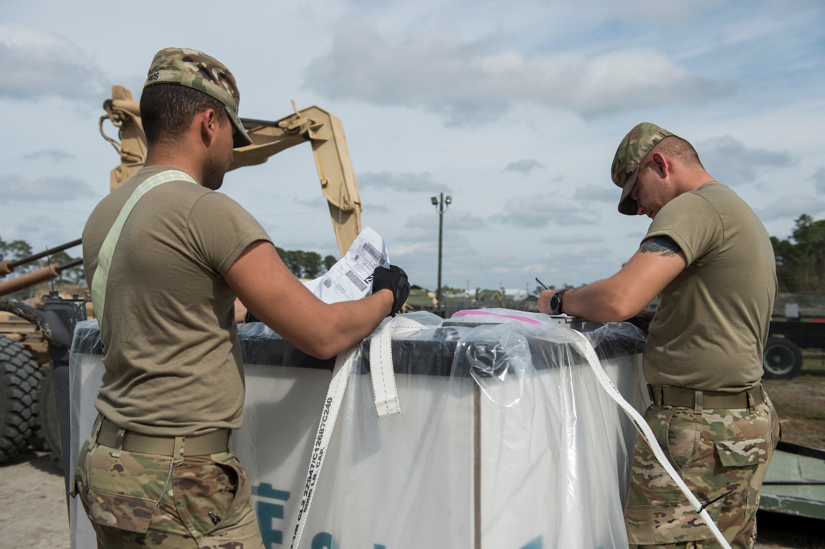 U.S. Army Spc. Yadiel Rios (left) and Sgt. Christopher Keys (right), 689th Rapid Port Opening Element transportation management coordinators, process simulated relief supplies as part of Exercise Turbo Distribution at Fort Stewart-Hunter Army Airfield, Georgia, Feb. 12, 2020. The Airmen are part of a Joint Task Force-Port Opening unit, a self-sustaining unit capable of rapidly loading and unloading aircraft cargo, maintaining and preparing equipment, and centralizing operations through a command and control station. (U.S. Air Force photo by Staff Sgt. Sarah Brice)