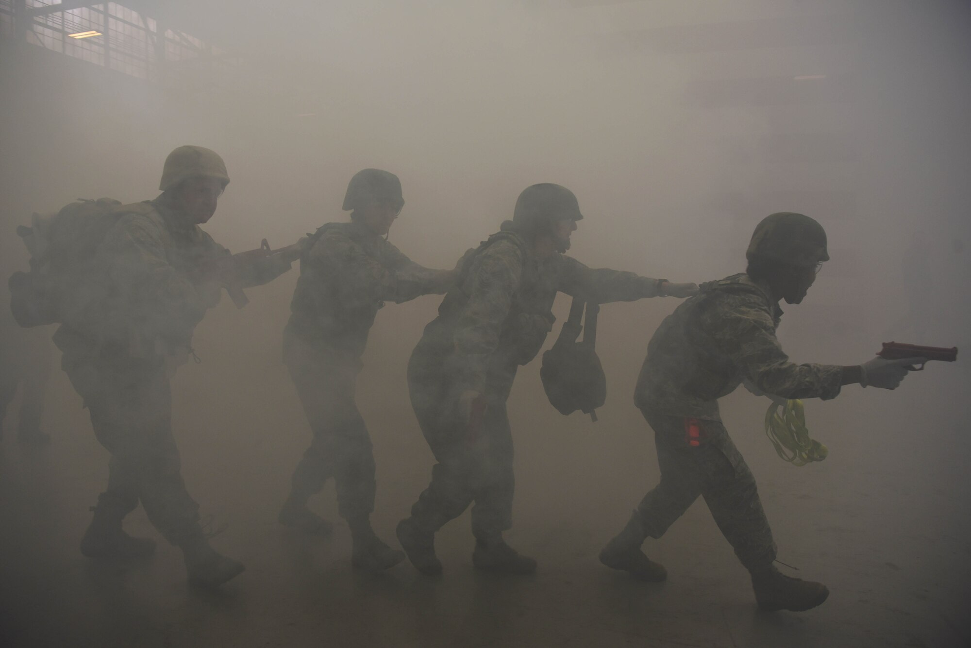 Airmen from the 14th Medical Group walk in a line into the simulated battlefield during the Tactical Combat Casualty Care Course in the Walker Center at Columbus Air Force Base Mississippi, Feb. 23, 2020. In the replicated training, Airmen were given rubber guns and full body gear to protect the “wounded” and other medics while providing treatment. (U.S. Air Force photo by Airman 1st Class Jake Jacobsen)