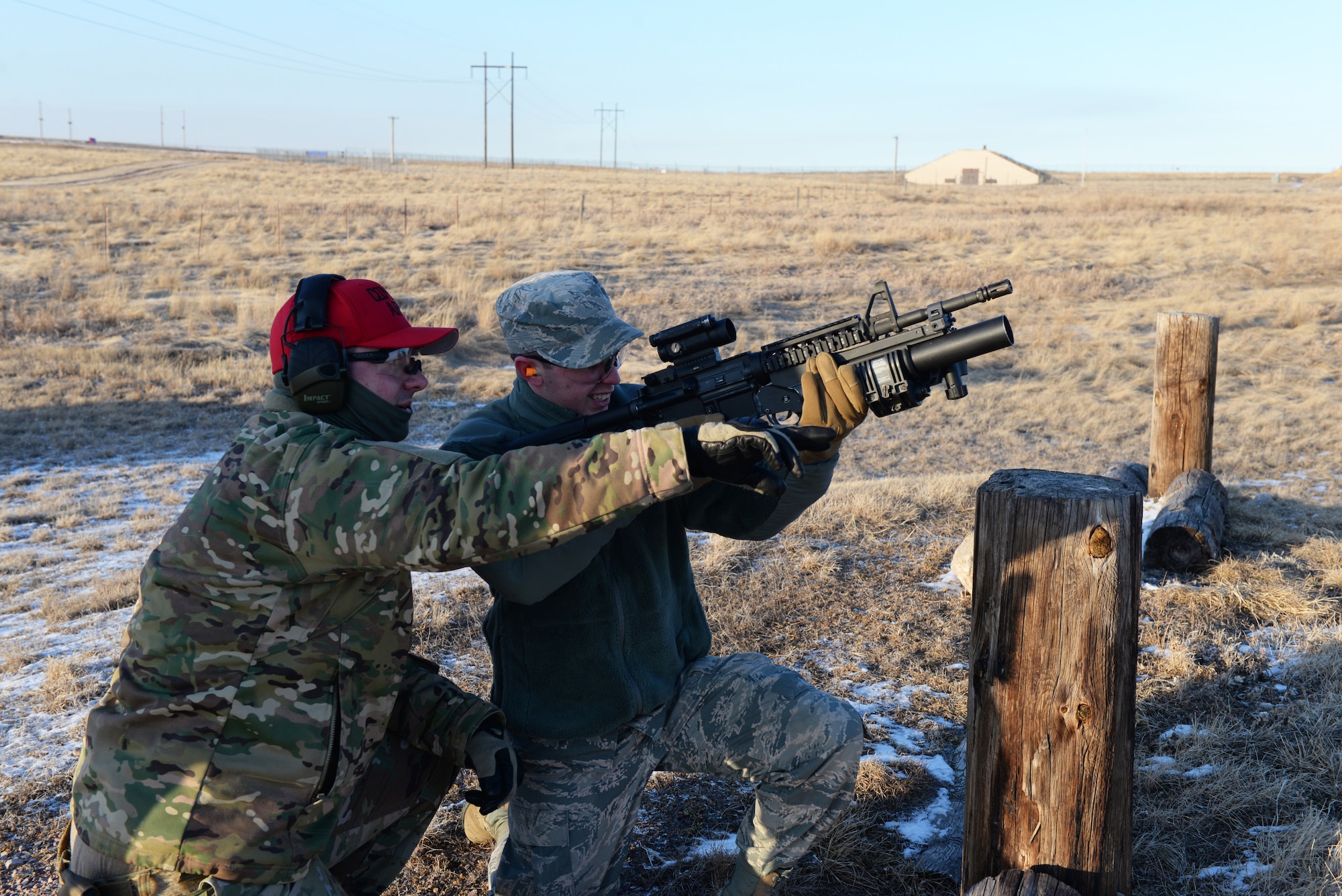 Combat Arms Airman trains Airman how to aim grenade launcher