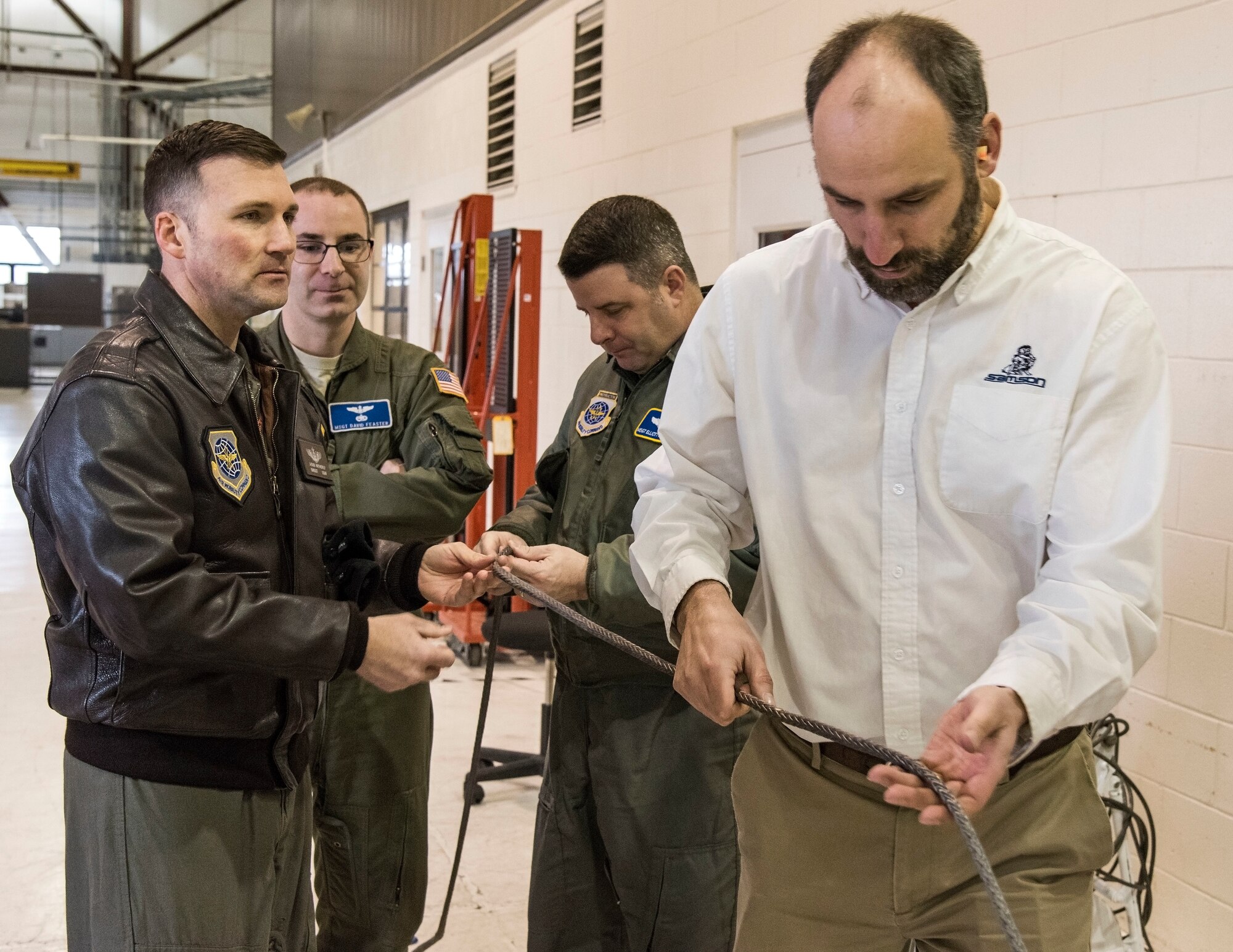 Personnel from the Air Force Research Lab, Wright-Patterson Air Force Base, Ohio and Samson Rope, Ferndale, Wash., demonstrate proposed items for the C-17 Globemaster III fleet Jan. 30, 2018, on Dover Air Force Base, Del. Maintenance personnel from the 736th Aircraft Maintenance Squadron set up an aircraft and back-shop facilities to gather additional data for synthetic rope chains and winch cable usage. (U.S. Air Force photo/Roland Balik)