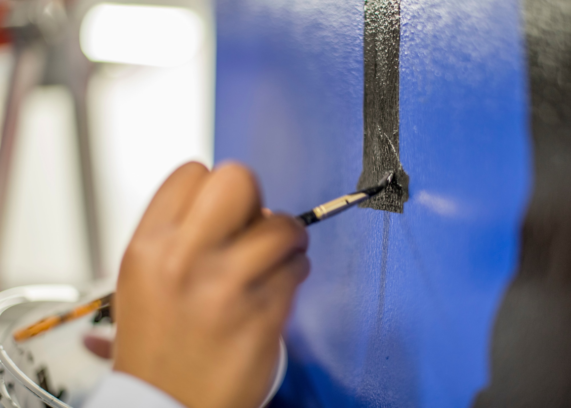 Airman 1st Class Te’Anne Dailey, 374th Security Forces Squadron patrolman, paints a mural at a main lobby of SFS’s building at Yokota Air Base, Japan, Feb. 7, 2020