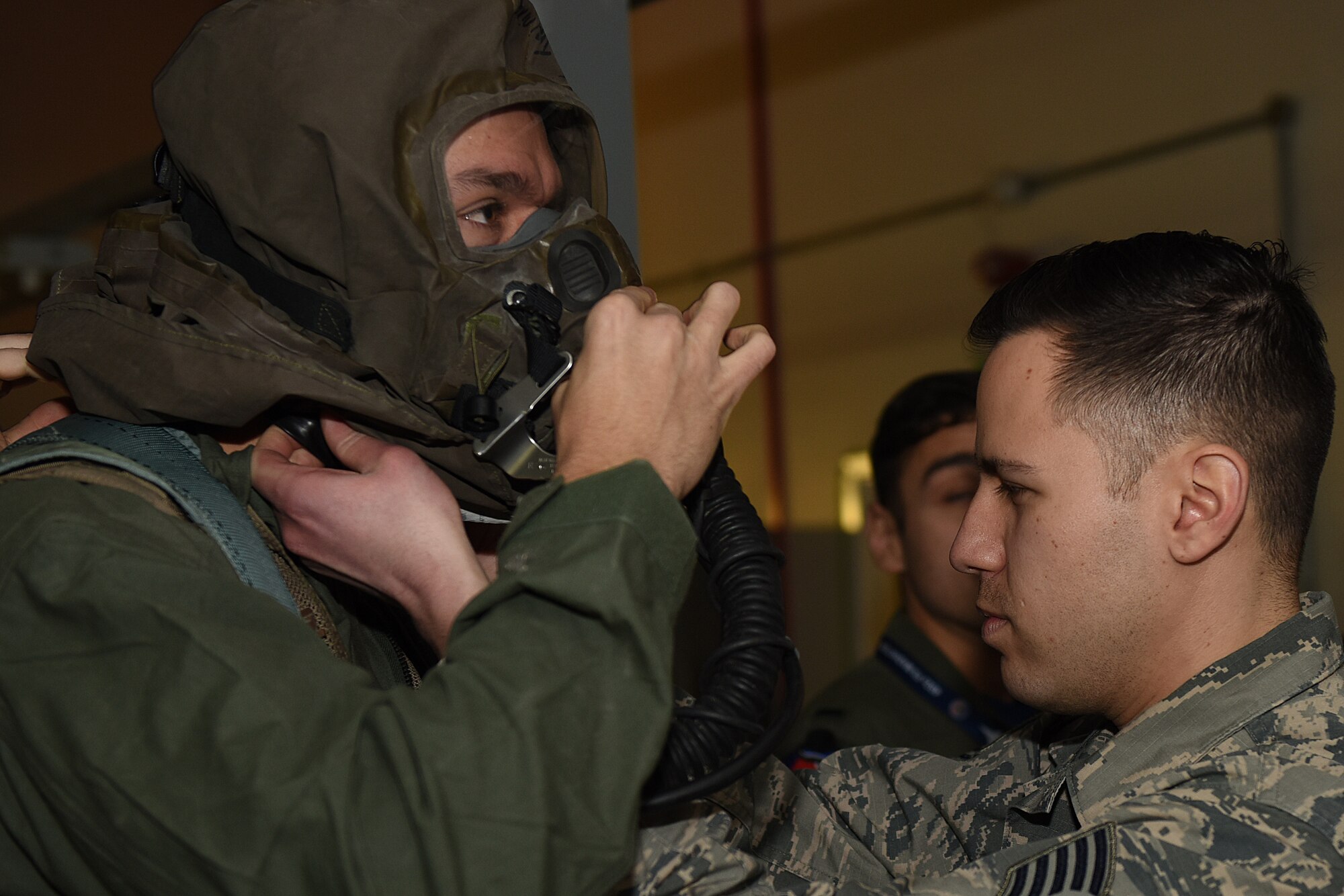 Tech. Sgt. David Vazquez Velez, 48th Fighter Wing Aircrew Flight Equipment, inspects mission-oriented protective posture gear during an Aircrew Contamination Control Area training exercise at Royal Air Force Lakenheath, England, Feb. 21, 2020. The training is conducted to ensure pilots and weapons systems officers can maintain mission readiness under any adverse conditions. (U.S. Air Force photo by Airman 1st Class Jessi Monte)