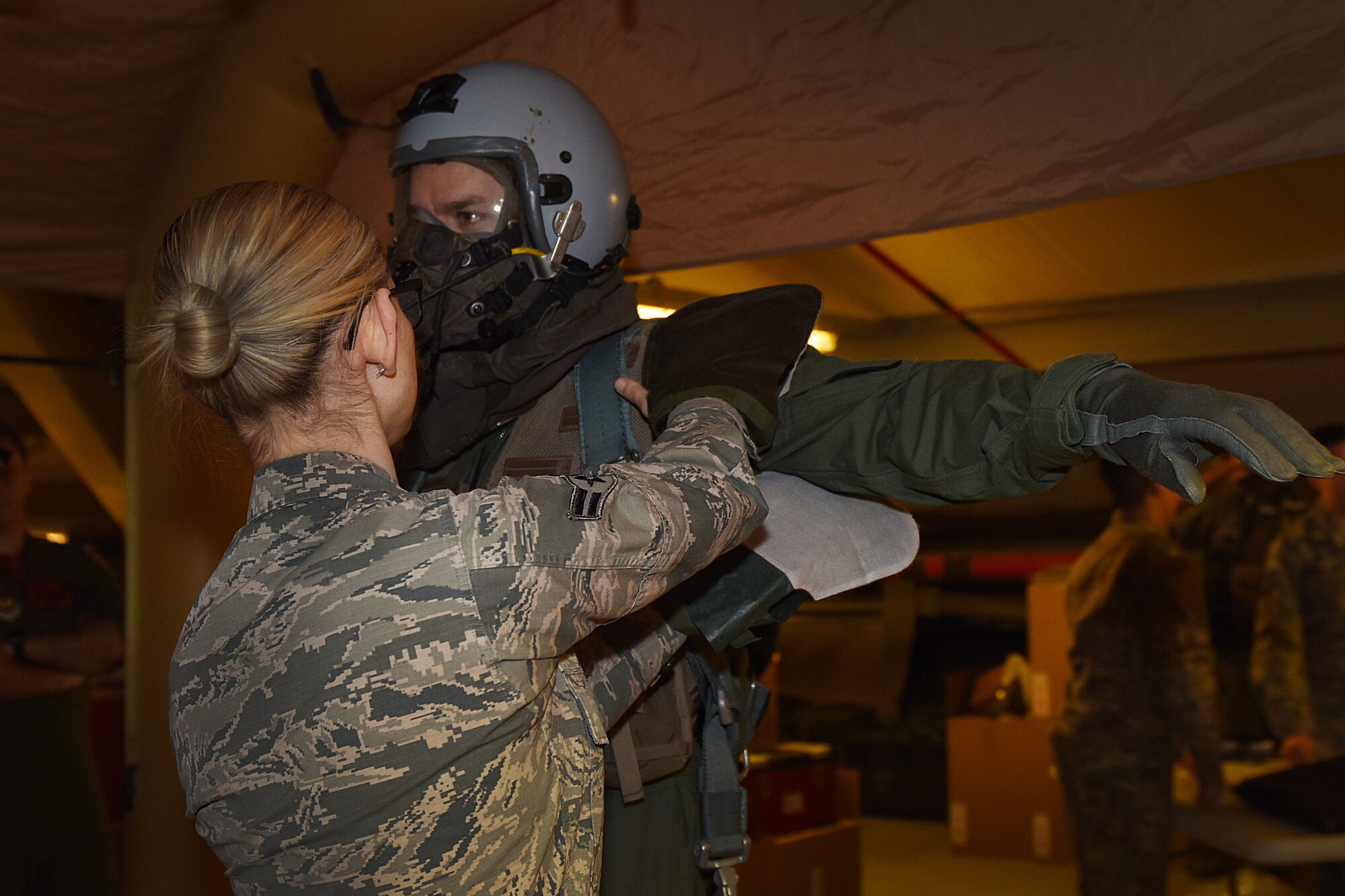 Capt. Erling German walks through decontamination procedures during an Aircrew Contamination Control Area training exercise at Royal Air Force Lakenheath, England, Feb. 21, 2020. The training is conducted to ensure aircrews can maintain mission readiness under any adverse conditions. (U.S. Air Force photo by Airman 1st Class Jessi Monte)