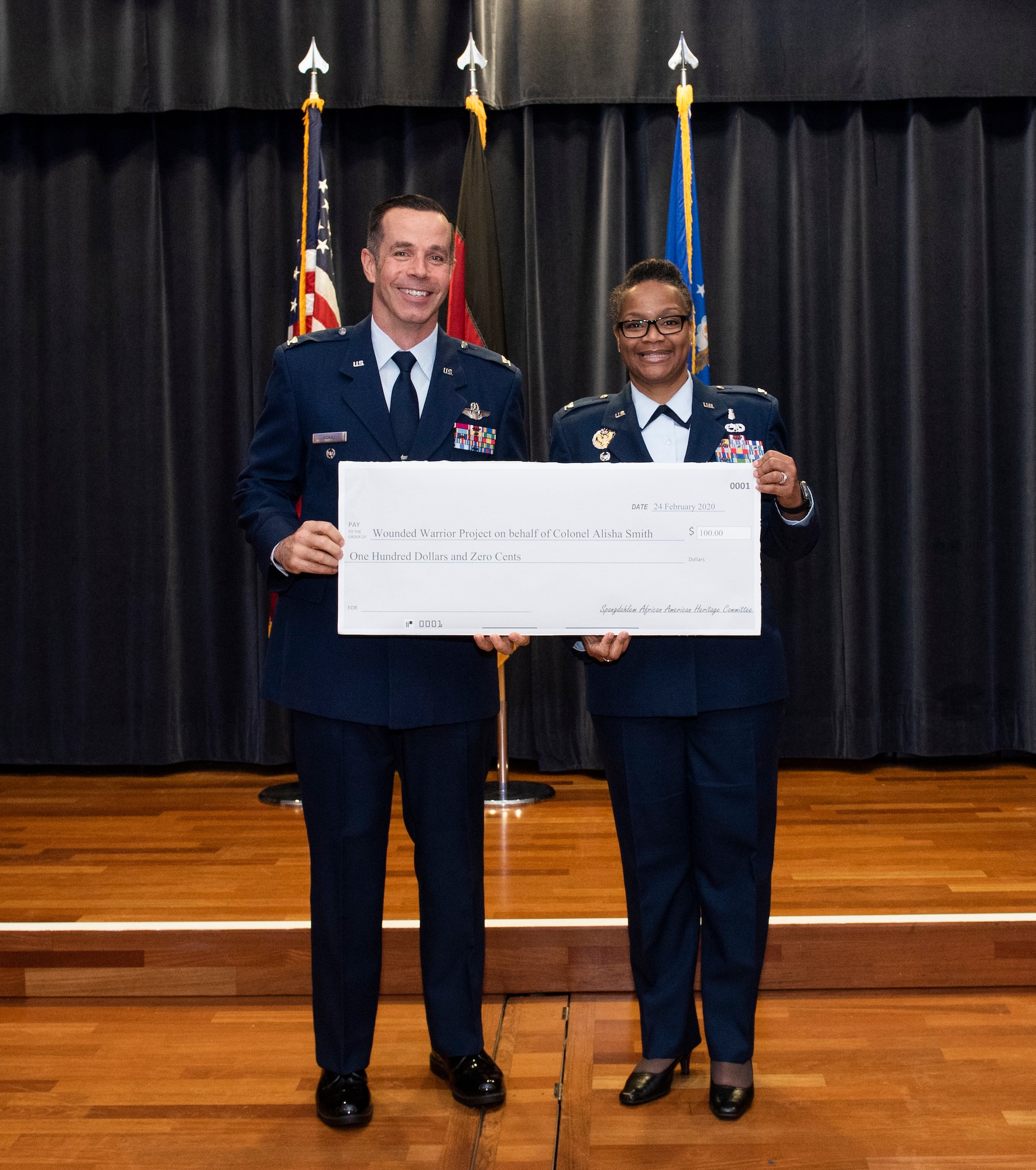 U.S. Air Force Col. Jason Hokaj, 52nd Fighter Wing vice commander, presents U.S. Air Force Col. Alisha Smith, 52nd FW Medical Group commander with a 100 dollar donation to the Wounded Warrior Project on her behalf at Spangdahlem Air Base, Germany, Feb. 24, 2020. 
The Wounded Warrior Project is a charity and veterans service organization that offers a variety of programs, services and events for wounded veterans of the military actions following September 11, 2001. (U.S. Air Force photo by Airman 1st Class Alison Stewart)