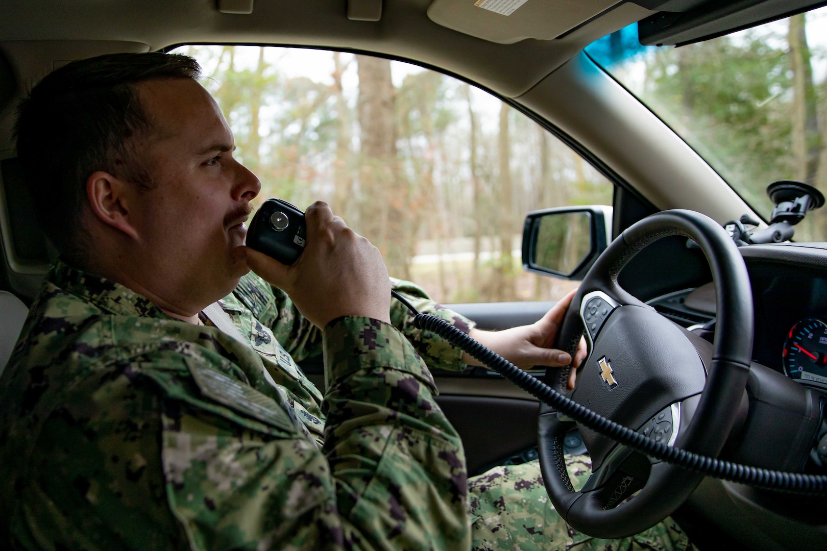 U.S. Navy Chief Yeoman Zach McKinley, assigned to the Joint Task Force Civil Support command group, performs a communication check with the command’s operations center as part of a routine vehicle roll out.