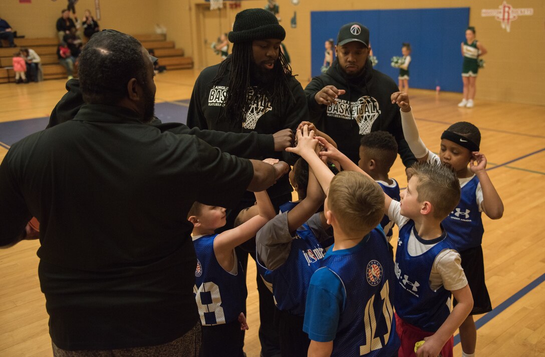 Coaches and players on a Langley Air Force Base Youth Sports Program basketball team have a huddle before beginning a game at the Youth Sports Center, Feb. 21, 2020. The LAFB YSP organizes teams for baseball, soccer, basketball, flag football and cheerleading. (U.S. Air Force photo by Airman 1st Class Sarah Dowe)