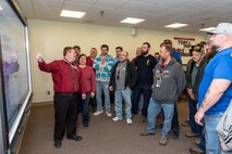 Photo of Ryan Stephenson using an electronic production control board to conduct his start up meeting with his team