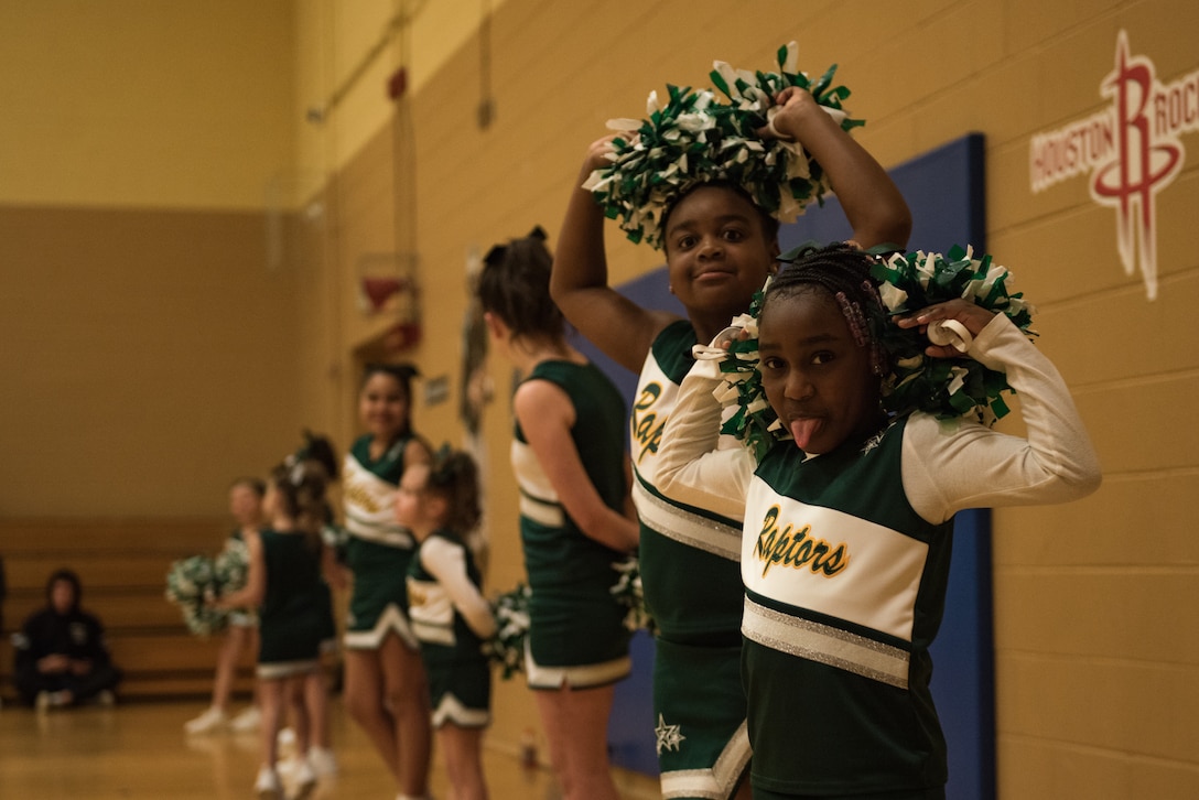Cheerleaders wait to begin their performance at a basketball game at the Youth Sports Center, Feb. 21, 2020. Children practice twice a week and have one to two games as well. (U.S. Air Force photo by Airman 1st Class Sarah Dowe)