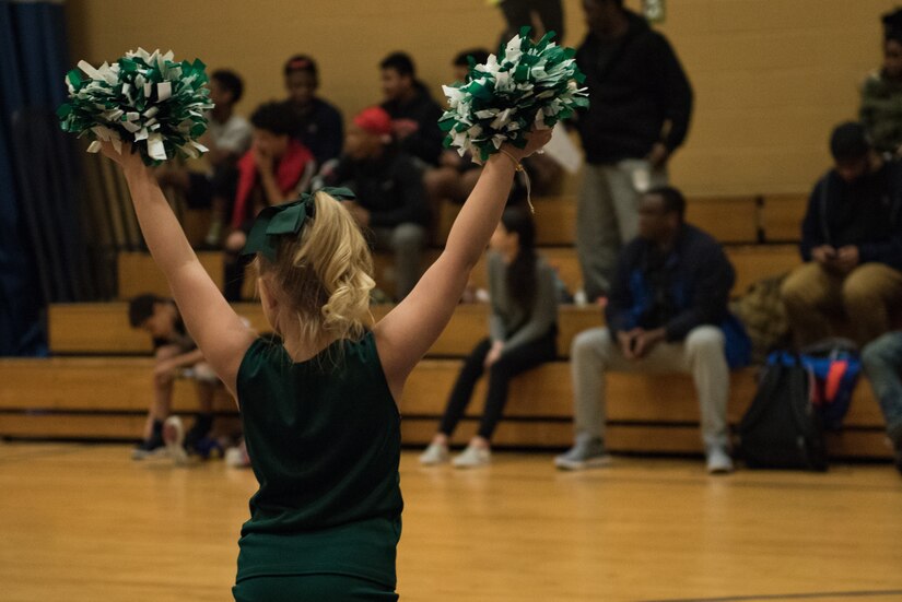 A cheerleader performs during halftime at a basketball game at the Youth Sports Center, Feb. 21, 2020. The Langley Air Force Base Youth Sports Program is available to dependents of Active Duty military members, retirees and Department of Defense employees from any branch of service. (U.S. Air Force photo by Airman 1st Class Sarah Dowe)