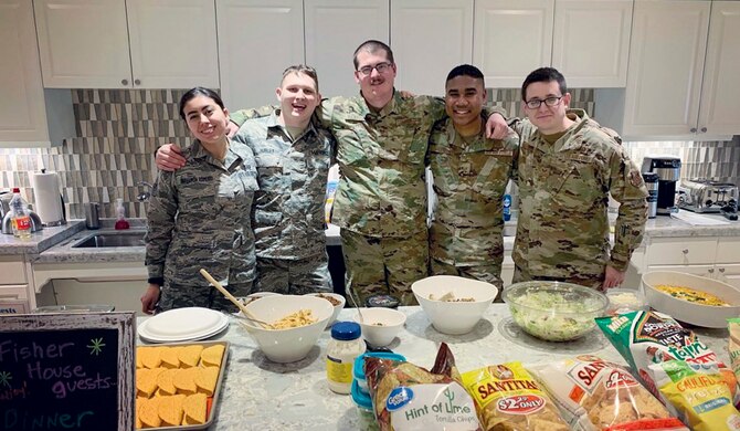 Tech. Sgt. Dustin Krasovic, Geospatial Intelligence Analysis Squadron member, cooks food at the Veterans Administration Medical Center Fisher House in Dayton, Ohio on Feb. 20, 2020. During the volunteer event, six members of the Geospatial Intelligence Analysis Squadron bought, prepared and cooked meals for veterans located at the medical center. (U.S. Air Force photo/Courtesy)