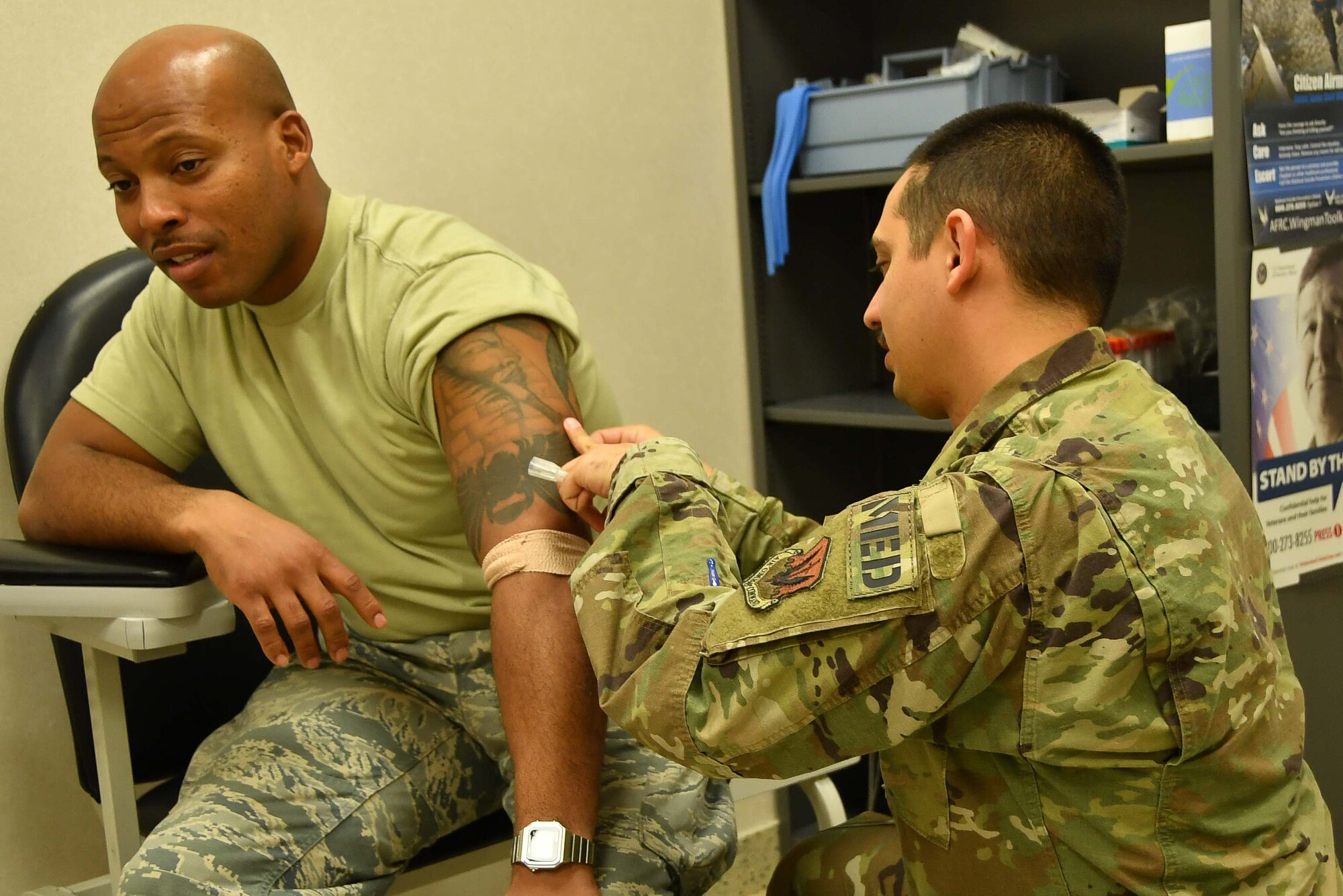 Tech. Sgt. Hector Gonzalez 24th Fighter Squadron Medical Operations NCOIC vaccinates Staff Sgt. Dennis Gipson Jr., 301st Fighter Wing Logistics Readiness Squadron vehicle operator during the February Unit Training Assembly February 1, 2020 at U.S. Naval Air Station Joint Reserve Base Fort Worth, Texas. Although assigned to the wing's active associate counterpart, Gonzalez is instrumental revamping parts of the occupational health program meant to take care of Airmen. (U.S. Air Force photo by Master. Sgt. Jeremy Roman)