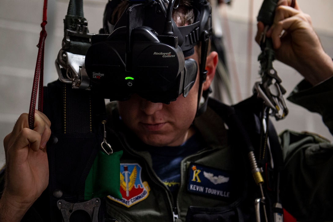 Photo of an emergency parachute training student using a parachute simulator.