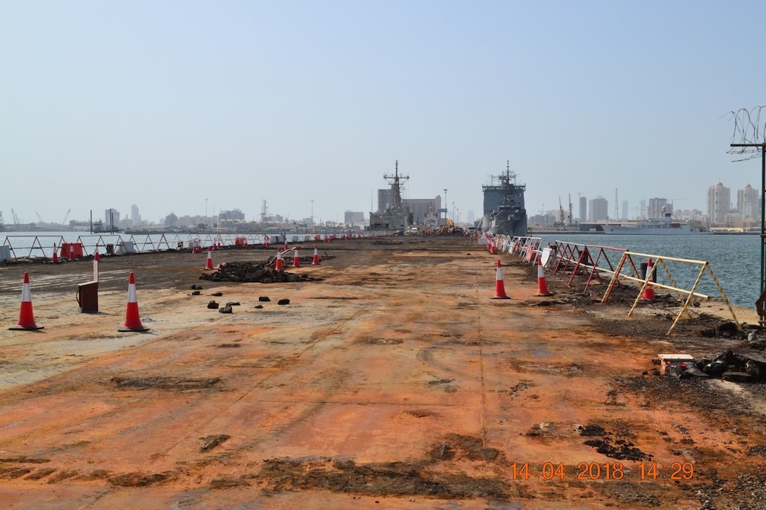 Photos of the old naval pier at Naval Support Activity Bahrain during the demolition phase of a U.S. Army Corps of Engineers Middle East District project to construct a new steel and concrete pier.