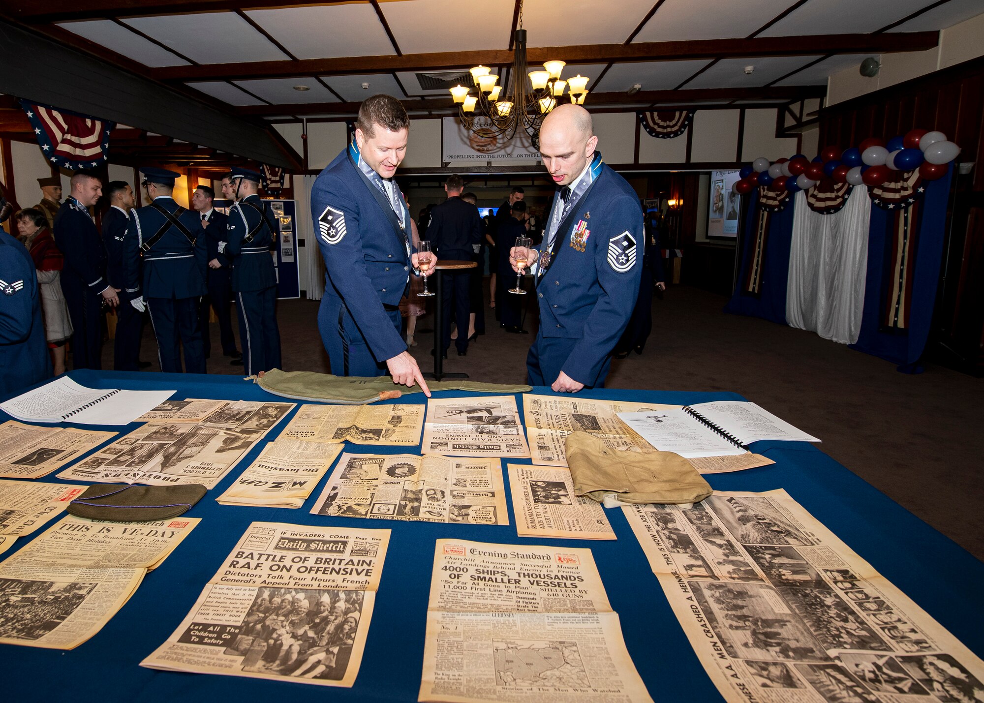Master Sgt. Daniel Strackbein, left, 423d Security Forces Squadron first sergeant, and MSgt Justin Sindelair, 422d Air Base Group first sergeant, read World War Two era newspapers, during the 2019 501st Combat Support Wing annual awards ceremony, at RAF Alconbury, England, Feb. 21, 2020.  The 501st CSW family came together to celebrate the Pathfinders that went above and beyond in the year of 2019. (U.S. Air Force photo by Senior Airman Eugene Oliver)