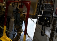 Staff Sgt Johnathan Fishel, a C-17 Globemaster III loadmaster assigned to the 15th Airlift Squadron at Joint Base Charleston, S.C., opens the cargo door in preparation for an air drop over Pope Army Airfield, N.C., Feb. 20, 2020.
