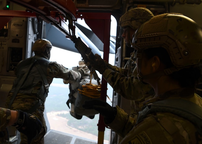 Soldiers assigned to the Airborne and Special Operations Test Directorate at Fort Bragg, N.C., eject a test mannequin out of a C-17 Globemaster III over Pope Army Airfield, N.C., Feb. 20, 2020.