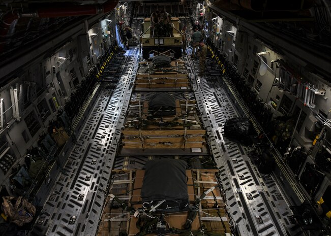 Staff Sgt. Johnathan Fishel, a C-17 Globemaster III loadmaster assigned to the 15th Airlift Squadron at Joint Base Charleston, S.C., and Technical Sgt. Casey Bradley, a loadmaster assigned to the Airborne and Special Operations Test Directorate at Pope Army Airfield, N.C., rig a humvee for an air drop at Pope Army Airfield, N.C., Feb. 19, 2020.