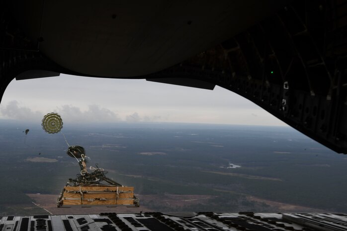 A loadmaster ejects a humvee out of a C-17 Globemaster III over Pope Army Airfield, N.C., Jan. 19, 2020. Airmen from the 15th AS integrated with the ABNSOTD to conduct air drop training for both services.
