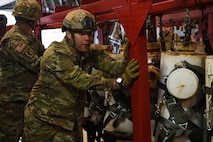 Sgt. 1st Class Marcus Love, a test parachutist assigned to the Airborne and Special Operations Test Directorate at Fort Bragg, N.C., helps load a test mannequin rack onto a C-17 Globemaster III at Pope Army Airfield, N.C., Feb.19, 2020.