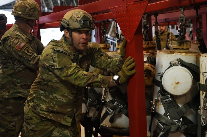 Sgt. 1st Class Marcus Love, a test parachutist assigned to the Airborne and Special Operations Test Directorate at Fort Bragg, N.C., helps load a test mannequin rack onto a C-17 Globemaster III at Pope Army Airfield, N.C., Feb.19, 2020.