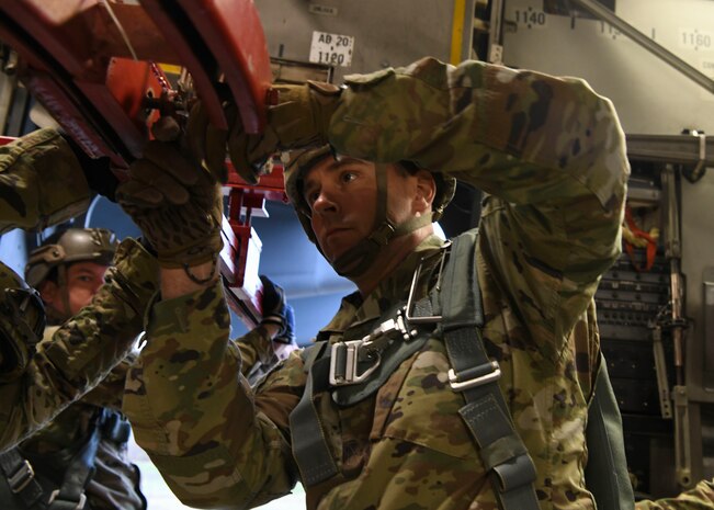 Sgt. 1st Class Jonathan Reed, an operations NCO assigned to the Airborne and Special Operations Test Directorate at Fort Bragg, N.C., prepares a mannequin rack for an air drop mid-flight on a C-17 Globemaster III over Pope Army Airfield, N.C., Feb. 20, 2020.