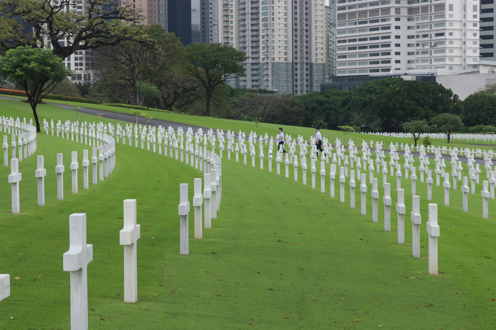 Airmen from Dyess Air Force Base, Texas, walk near the graves of fallen service members at the Manila American Cemetery in Manila, Philippines, Feb. 17, 2020.