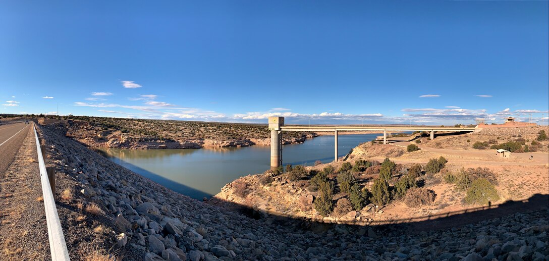 View of  Santa Rosa Dam's upstream embankment face, the reservoir, the service bridge and tower, and the visitor center overlook at sunset, Feb. 10, 2020.