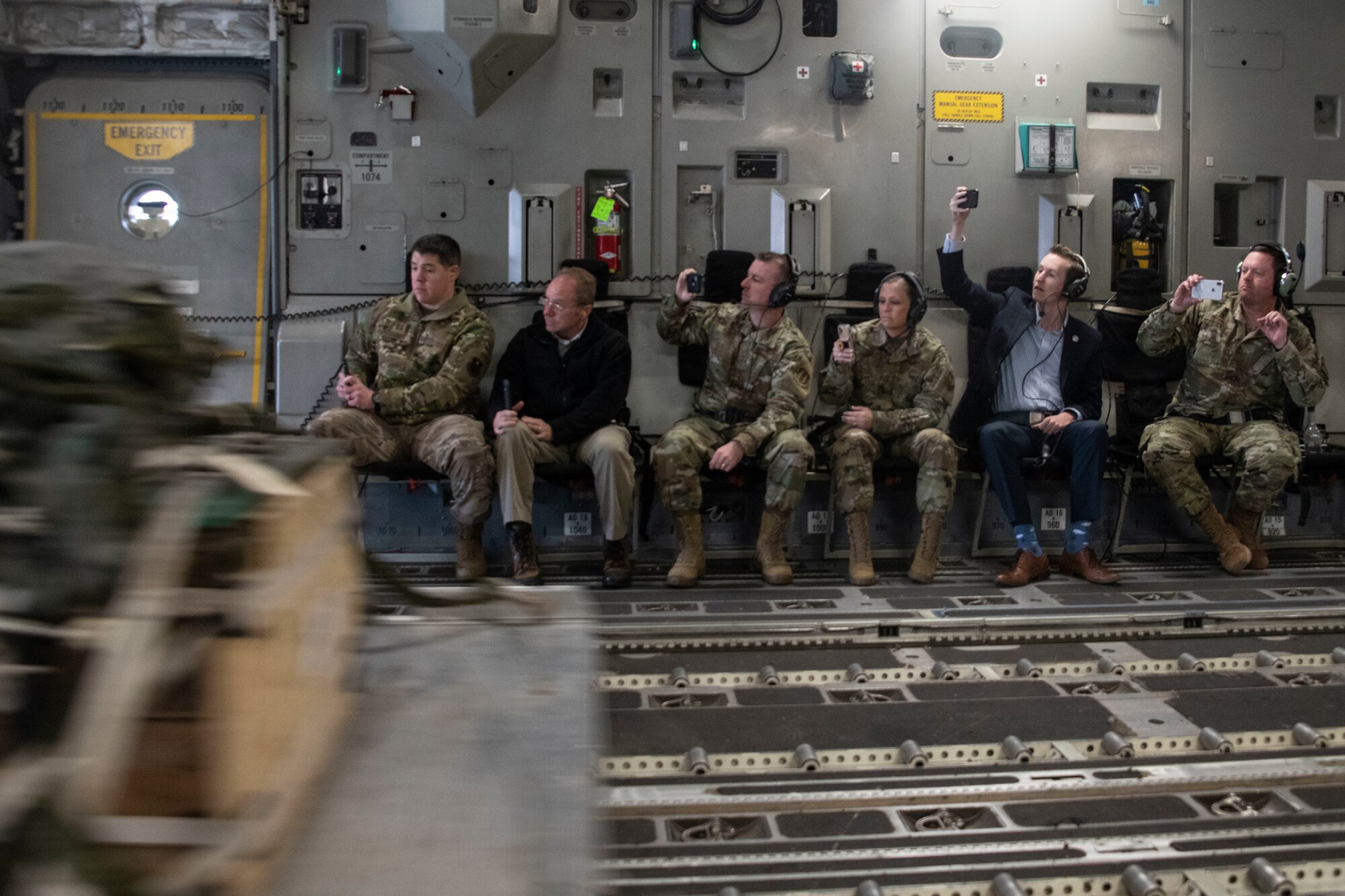 Members of the Oklahoma Commanders Summit watch as an air drop pallet slides out of a C-17 Globemaster III, Feb. 3, 2020, in the skies of Oklahoma. The summit allowed the opportunity for installation commanders to meet with one another and obtain a wider perspective of other bases mission and capabilities. (U.S. Air Force photo by Staff Sgt. Cody Dowell)