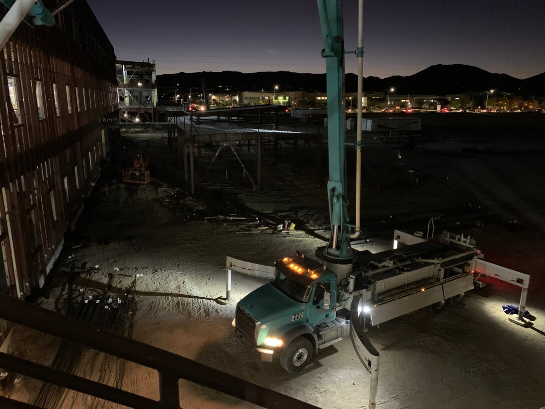 Workers pump concrete at dawn at the NNSA Albuquerque Complex site, Oct. 31, 2019.