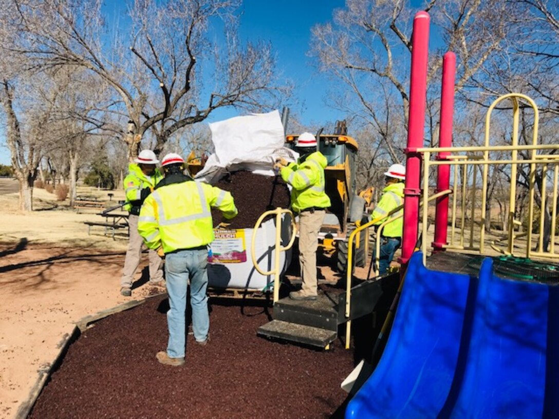 Conchas Lake staff spread rubber mulch in the Captain Kramer playground day use area, Feb. 28, 2019.
