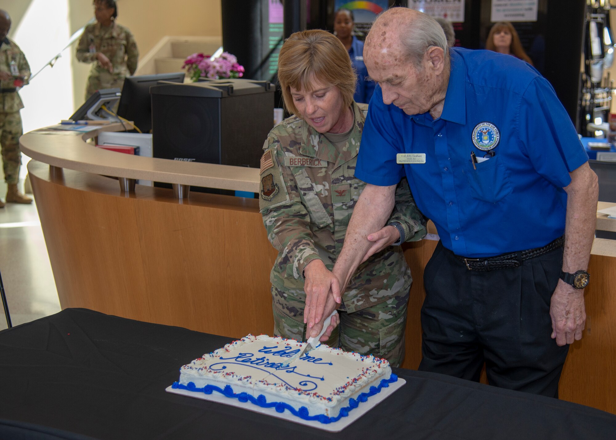 U.S. Air Force Col. Christine Berberick, the 6th Medical Group commander, cuts a ceremonial cake with retired Col. William Graham, the MacDill Retiree Activities Office director, at the Retiree Appreciation Day event Feb. 22, 2020, at MacDill Air Force Base, Fla.