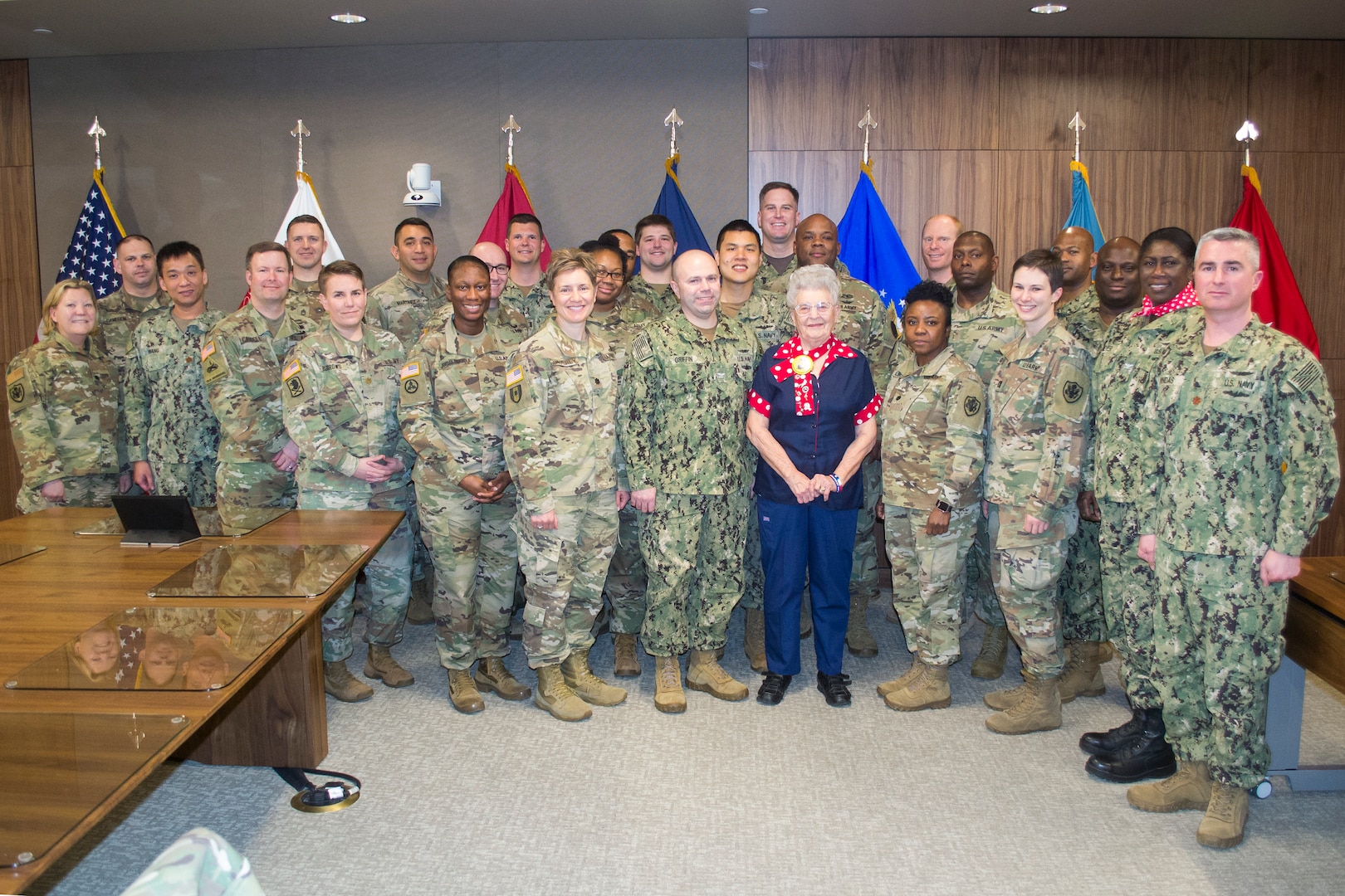 DLA Troop Support military personnel pose with Mae Krier, a real-life “Rosie the Riveter” who spoke to them during a Leadership and Professional Development session Feb. 20 in Philadelphia. Krier spoke about her experiences as a riveter, working on B-17 Flying Fortress and B-29 Superfortress bombers during WWII.