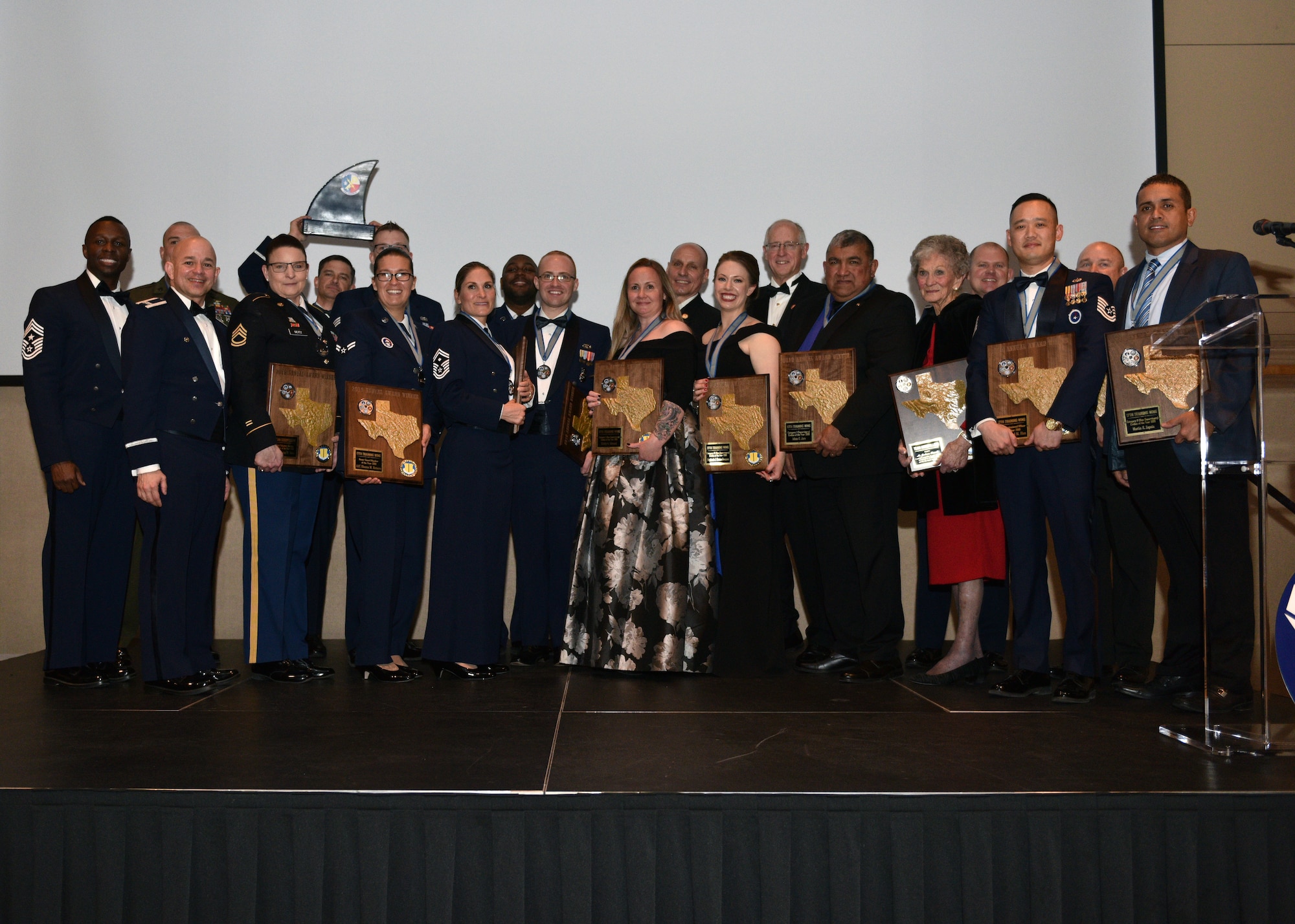 The award winners present their accolades after the 27th Annual Awards Ceremony at the McNeese Convention Center in San Angelo, Texas, Feb. 21, 2020. Over twenty awards were presented during the event. (U.S. Air Force photo by Airman 1st Class Robyn Hunsinger)